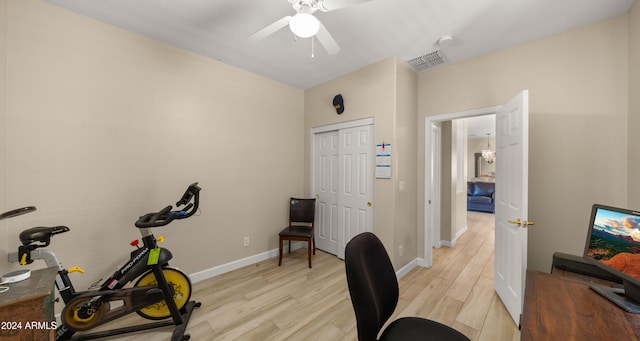 home office with light wood-type flooring and ceiling fan