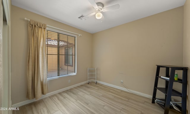 spare room featuring ceiling fan and light wood-type flooring