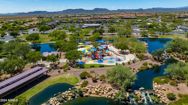 drone / aerial view featuring a water and mountain view