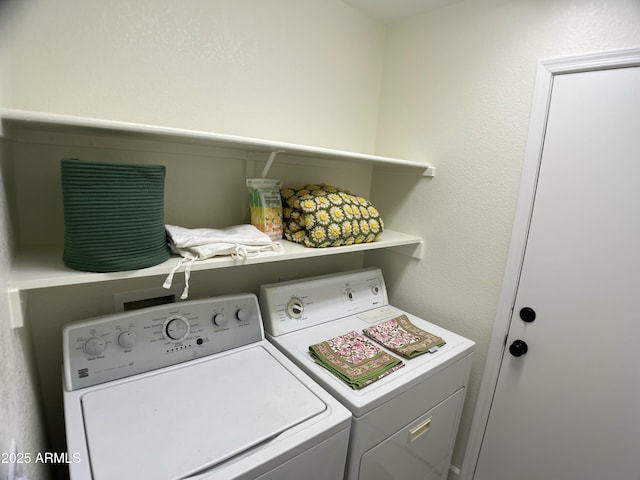 laundry area featuring separate washer and dryer and laundry area