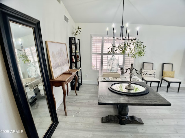 dining room with baseboards, an inviting chandelier, light wood-style flooring, and visible vents