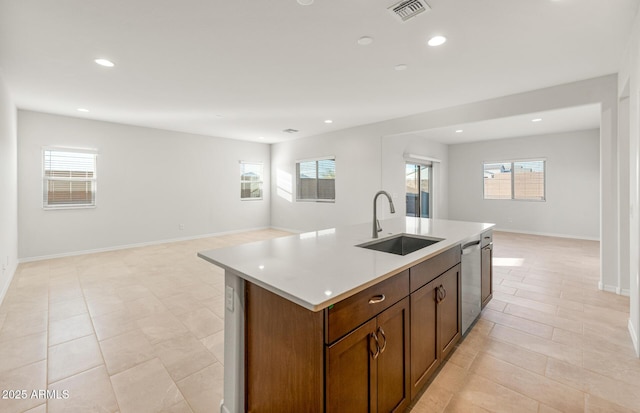 kitchen featuring sink, a wealth of natural light, and a center island with sink