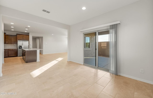 unfurnished living room featuring light tile patterned floors