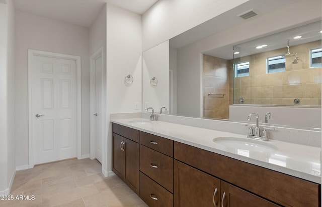 bathroom with vanity and tiled shower