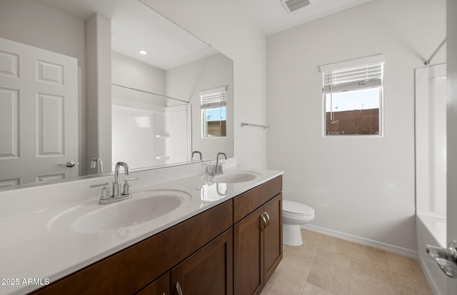 bathroom with tile patterned flooring, vanity, a shower, and toilet