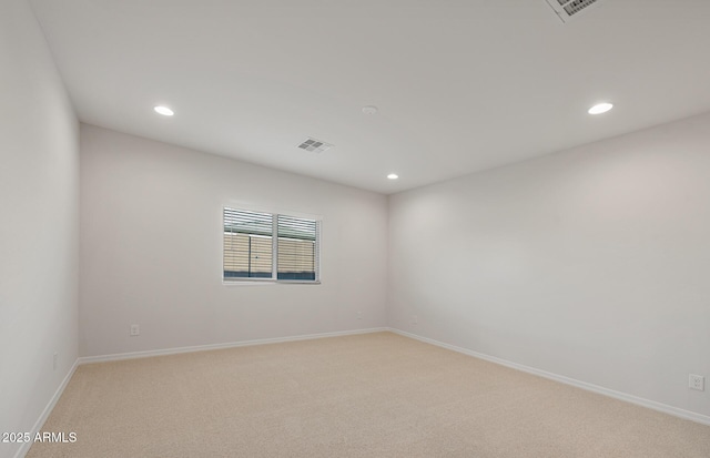 unfurnished room featuring light colored carpet