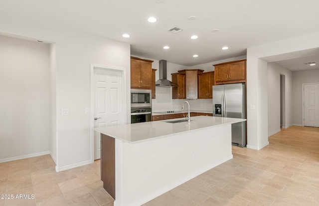 kitchen with tasteful backsplash, an island with sink, sink, stainless steel appliances, and wall chimney range hood