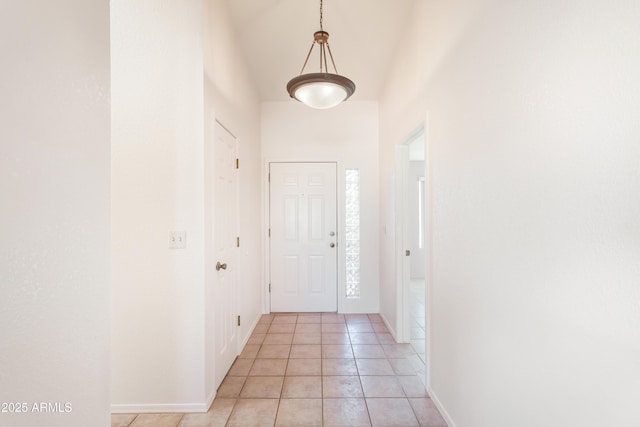 doorway to outside with light tile patterned floors