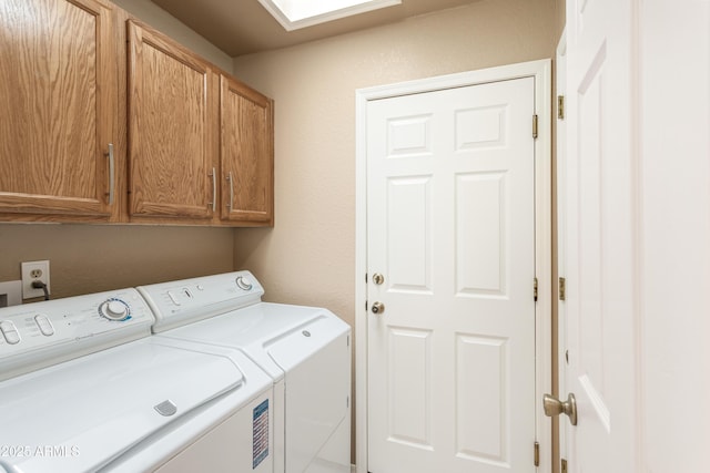 laundry room with cabinets and washing machine and clothes dryer