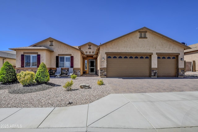 5552 N Kerwood Loop, Prescott Valley, AZ 86314 - view of front facade with stone siding, driveway, a garage, and stucco siding