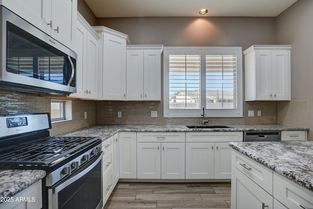 5552 N Kerwood Loop, Prescott Valley, AZ 86314 - kitchen featuring appliances with stainless steel finishes, recessed lighting, white cabinetry, decorative backsplash, and light wood-style flooring