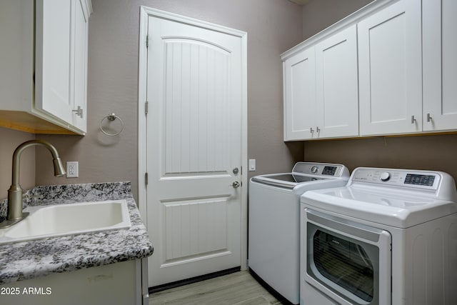 5552 N Kerwood Loop, Prescott Valley, AZ 86314 - washroom with cabinet space, separate washer and dryer, and light wood finished floors