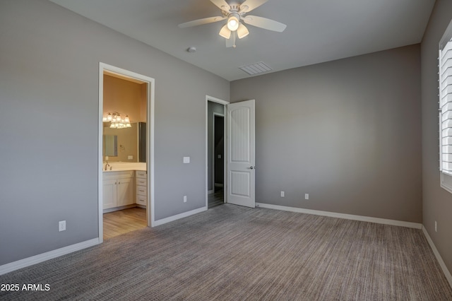 5552 N Kerwood Loop, Prescott Valley, AZ 86314 - unfurnished bedroom featuring light colored carpet, ensuite bathroom, and a ceiling fan