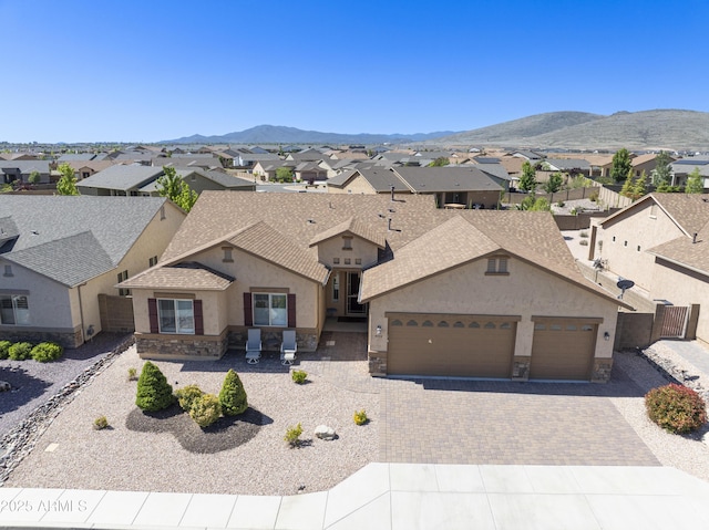 5552 N Kerwood Loop, Prescott Valley, AZ 86314 - view of front facade featuring stucco siding, stone siding, an attached garage, and decorative driveway