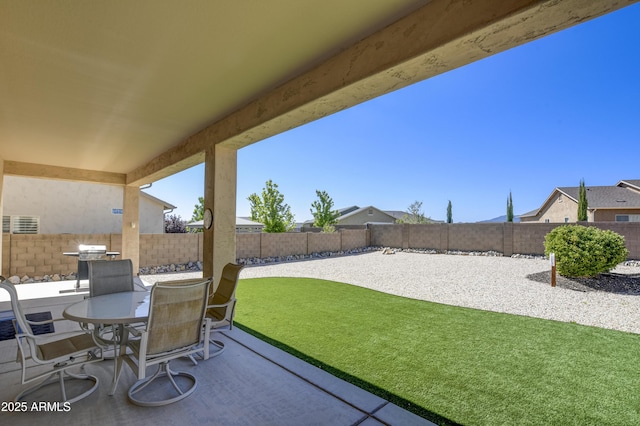 5552 N Kerwood Loop, Prescott Valley, AZ 86314 - fenced backyard featuring a patio, outdoor dining space, and area for grilling