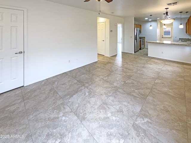 unfurnished living room featuring ceiling fan