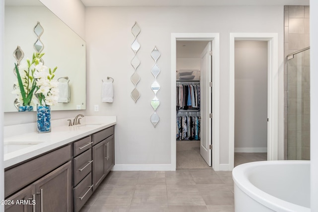 bathroom with tile patterned flooring, vanity, and independent shower and bath