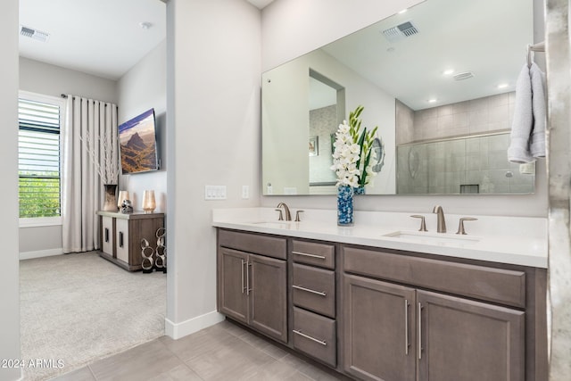 bathroom featuring vanity, a shower with shower door, and tile patterned floors