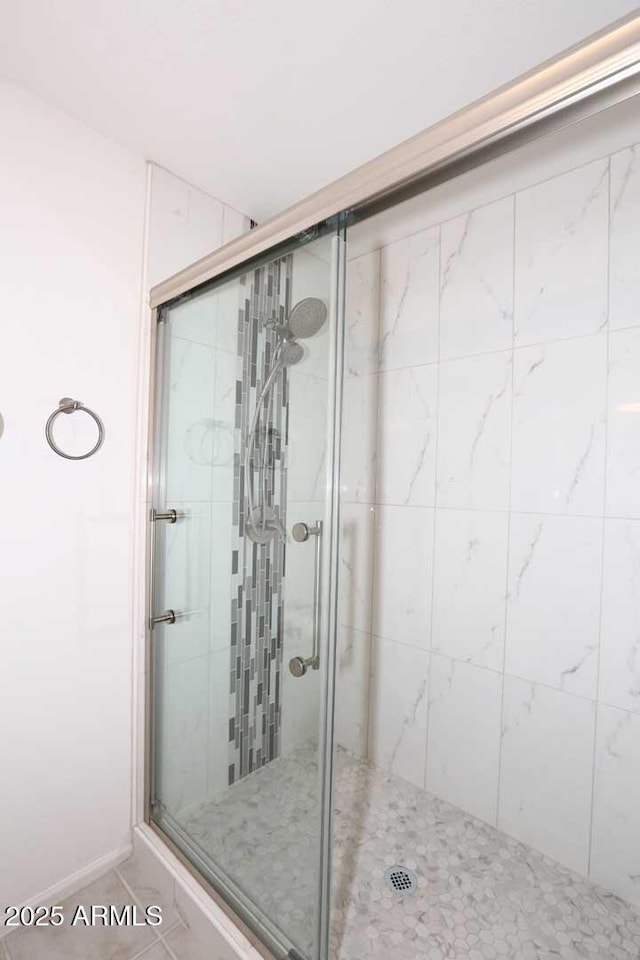 bathroom featuring a stall shower and tile patterned flooring