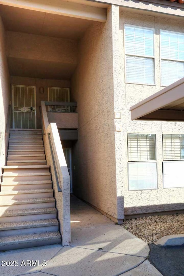 property entrance with stucco siding