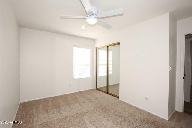 unfurnished bedroom featuring carpet flooring, a closet, and baseboards