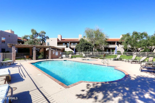community pool featuring fence and a patio