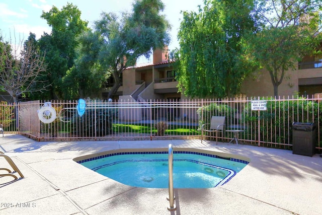 view of swimming pool with fence and a patio area