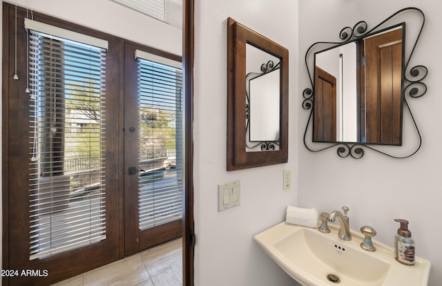 bathroom with sink, tile floors, and french doors