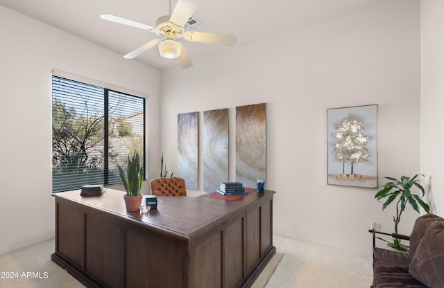 carpeted office space with ceiling fan