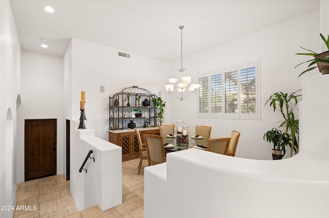 dining room with light tile floors and a notable chandelier