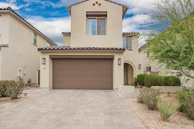 10050 E Texas Ave, Mesa, AZ 85212 - mediterranean / spanish-style house featuring stucco siding, driveway, a tile roof, and an attached garage