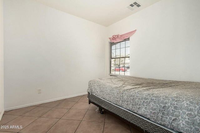 bedroom featuring visible vents, baseboards, and light tile patterned floors