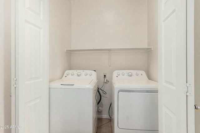 washroom featuring washing machine and dryer and laundry area