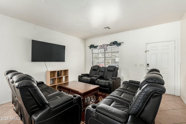 living area with light tile patterned floors, baseboards, and visible vents