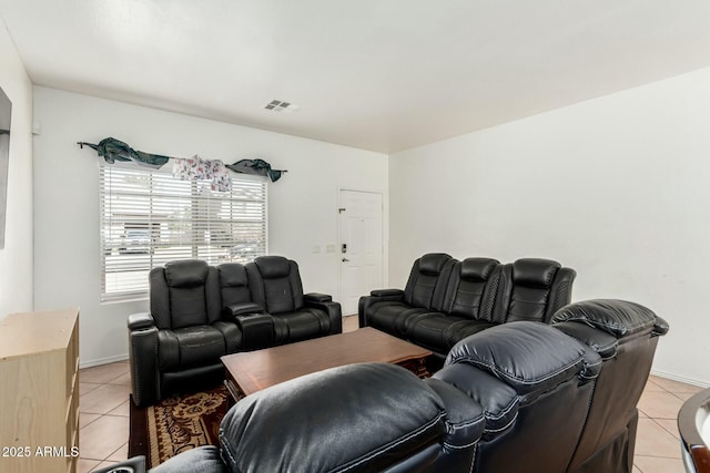 living room with light tile patterned floors, visible vents, and baseboards