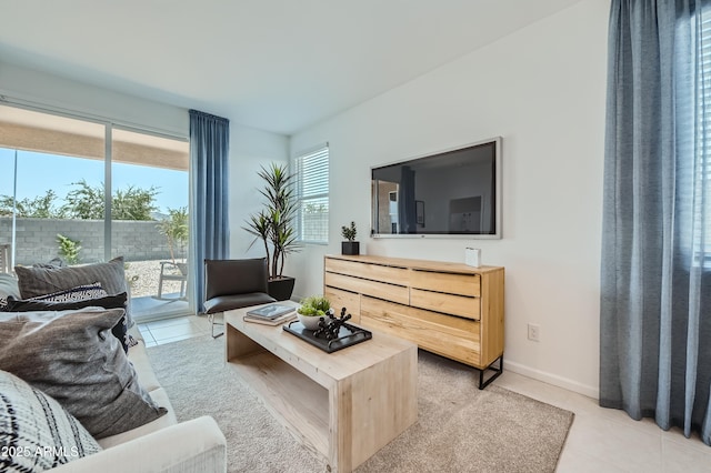 living room featuring light tile patterned floors and baseboards