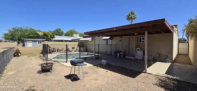 10408 W Devonshire Ave, Phoenix, AZ 85037 - back of house with a patio, a fenced backyard, stucco siding, an outdoor structure, and a storage unit