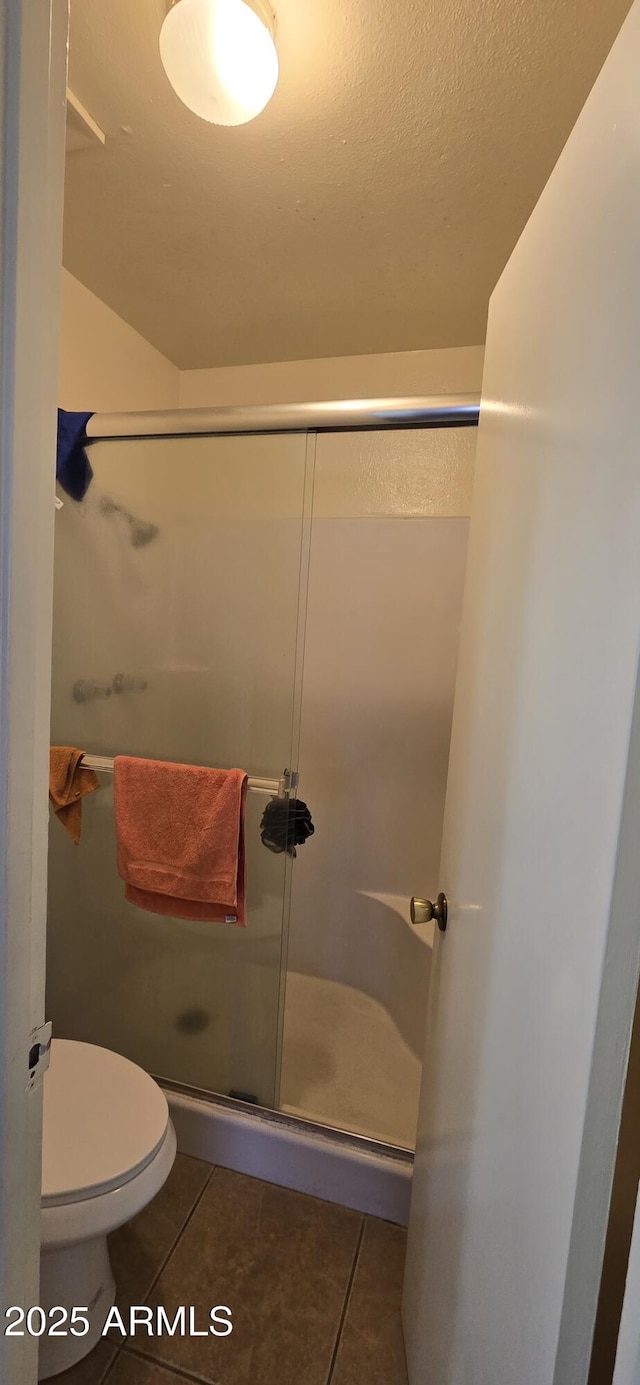 10408 W Devonshire Ave, Phoenix, AZ 85037 - bathroom with tile patterned flooring, a shower stall, toilet, and a textured ceiling