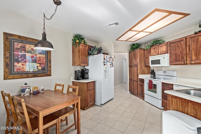 4725 E Brown Rd Unit 79, Mesa, AZ 85205 - kitchen featuring white appliances, light tile patterned flooring, brown cabinetry, and light countertops