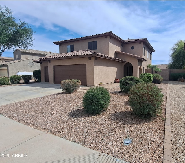 15953 W Custer Ln, Surprise, AZ 85379 - mediterranean / spanish-style house featuring driveway, a tiled roof, an attached garage, fence, and stucco siding