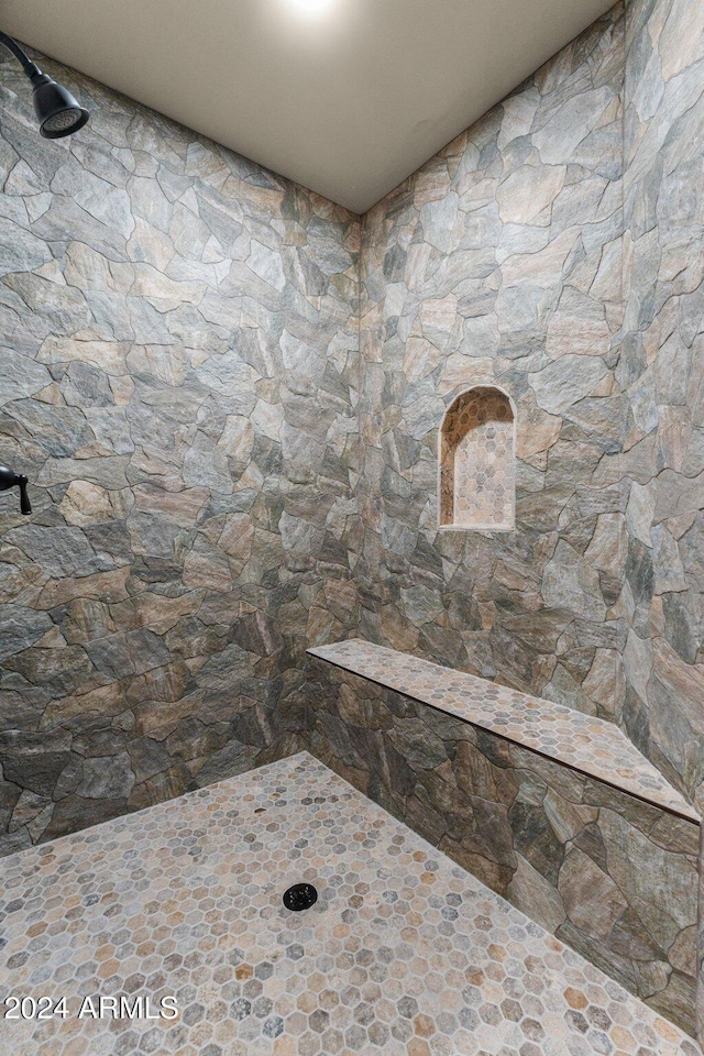 full bathroom with tiled shower