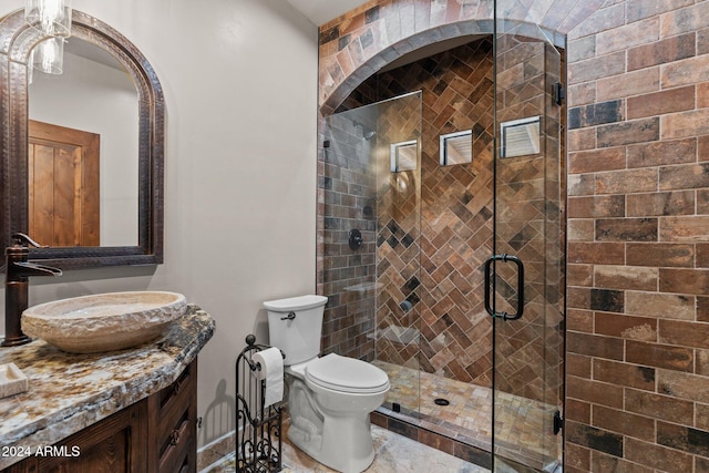 full bath featuring a shower stall, toilet, and vanity