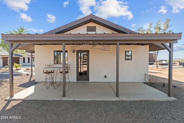 back of property featuring stucco siding and a patio area