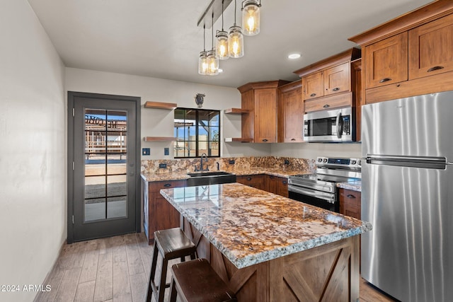 kitchen featuring a sink, open shelves, brown cabinets, and stainless steel appliances