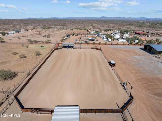 drone / aerial view featuring view of desert and a mountain view