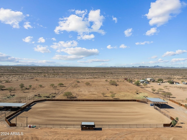 drone / aerial view featuring a mountain view, a rural view, and a desert view