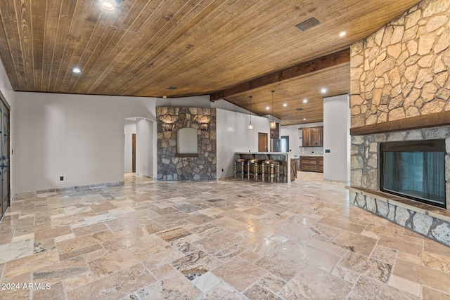 unfurnished living room featuring a fireplace, vaulted ceiling with beams, wood ceiling, and recessed lighting