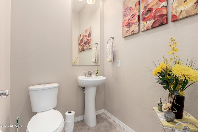 bathroom featuring tile patterned floors and toilet