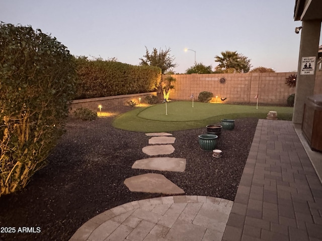 yard at dusk with a patio