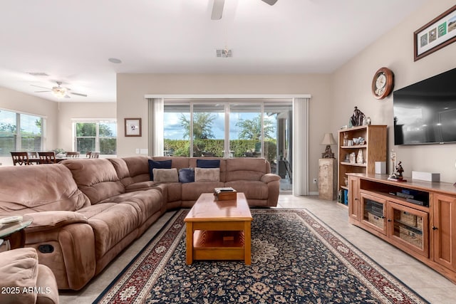 tiled living room with ceiling fan